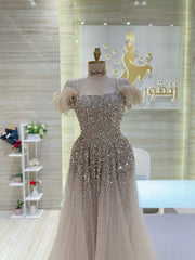 A soft pink, off-the-shoulder dress with delicate lace details, perfect for an engagement party.